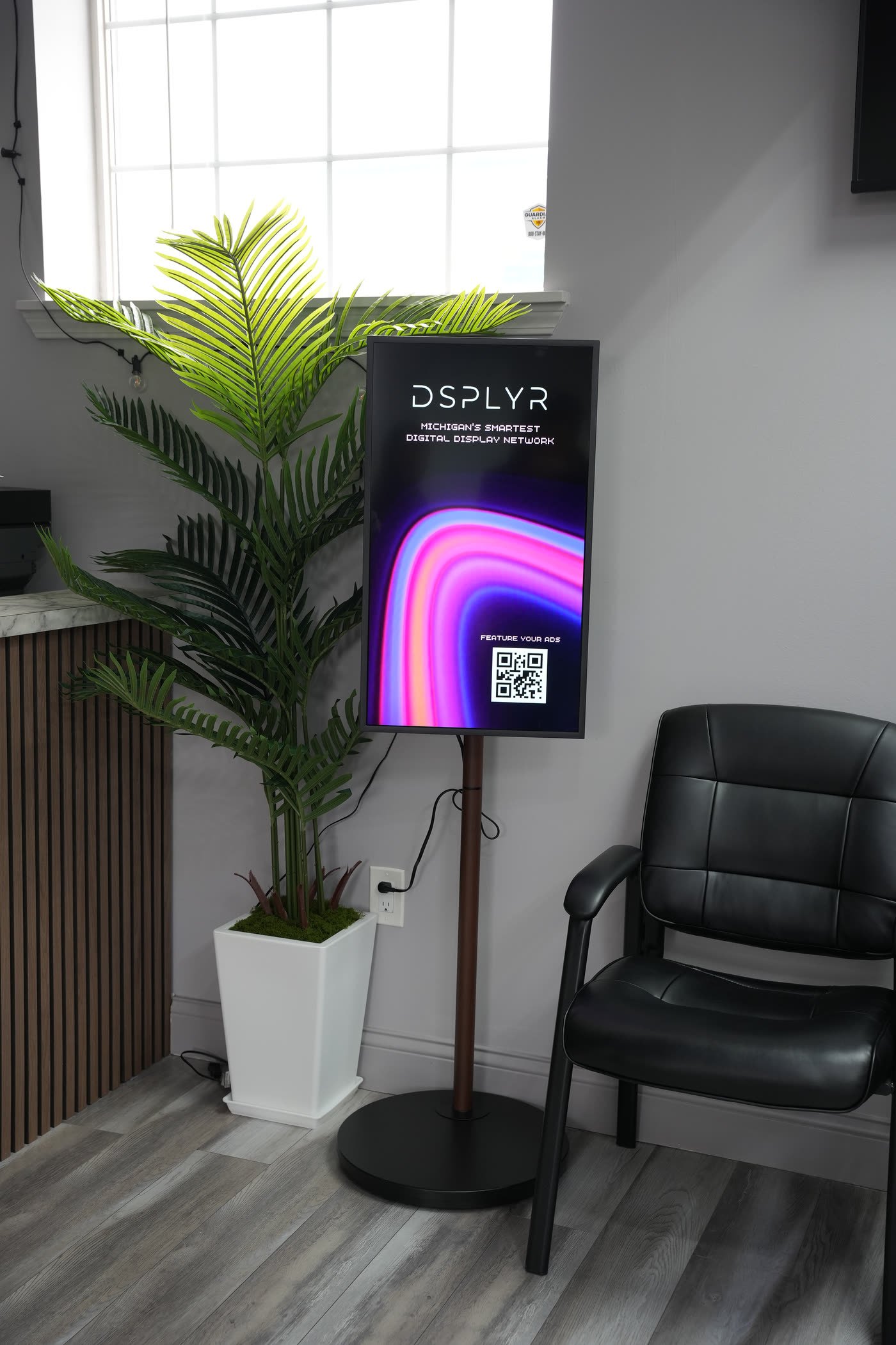 A DSPLYR screen installed in the waiting area of Lifetime Rx pharmacy